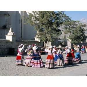 Girls in Traditional Local Dress Dancing in Square at Yanque Village 