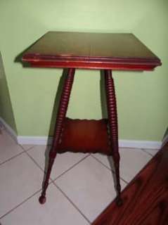 This lovely antique table has a square top with beveled edge. It is 