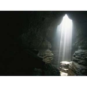  Beam of Sunlight Shines on a Rock Pedestal in a Cave 