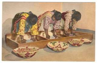 This is a linen postcard of Pueblo Indian women grinding grain 