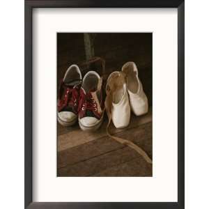  A Pair of Ballet Toe Shoes Rest Next to a Pair of Tennis Shoes 